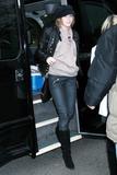 Miley Cyrus in black leather jacket and boots